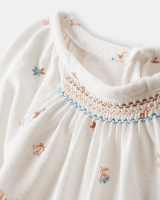 Body de manga larga floral con cuello de volantes en algodón