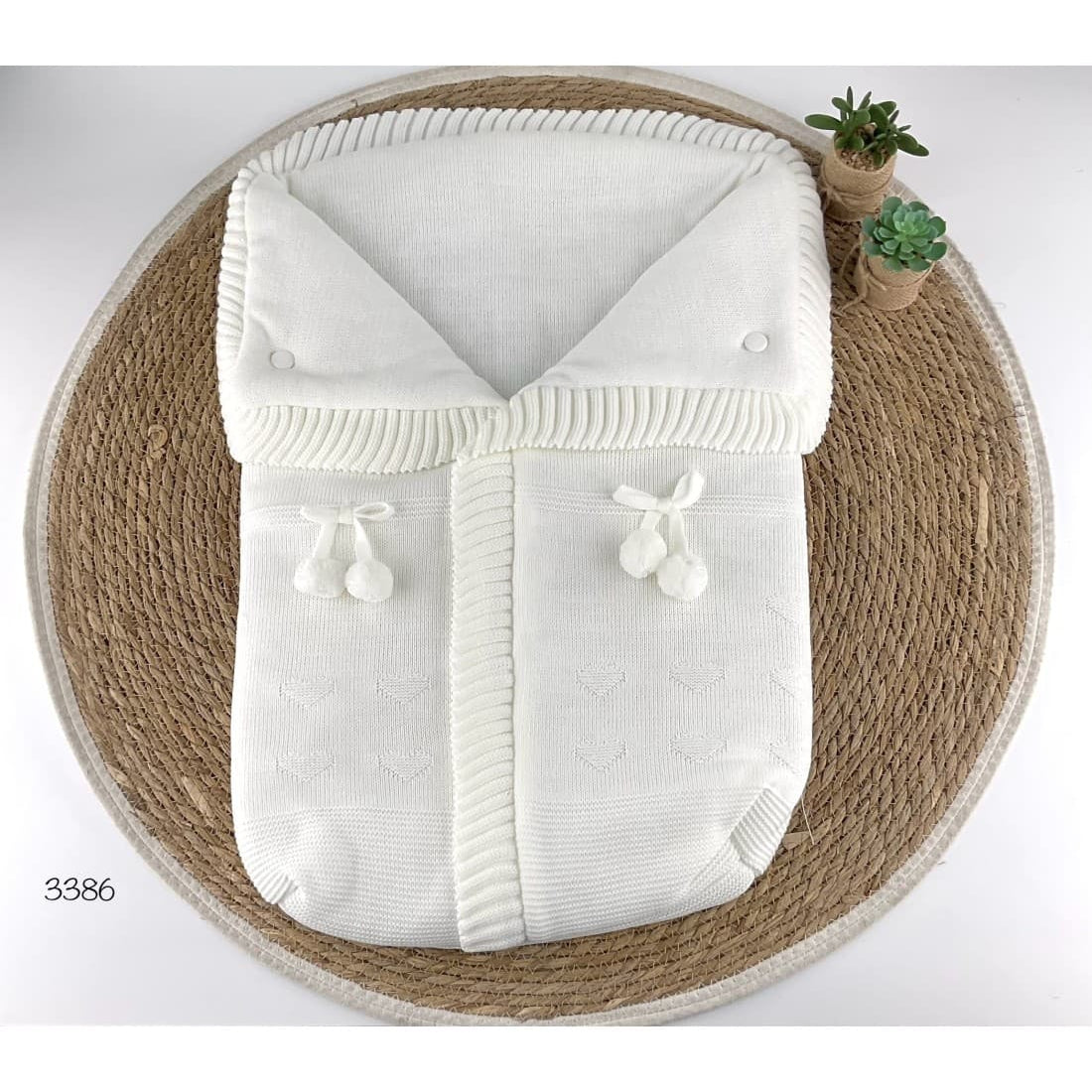 Saco de lana para bebé con pompones decorativos 521103386