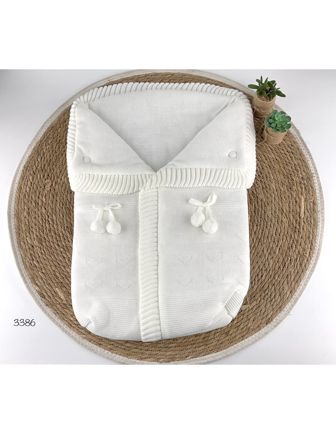 Saco de lana para bebé con pompones decorativos 521103386