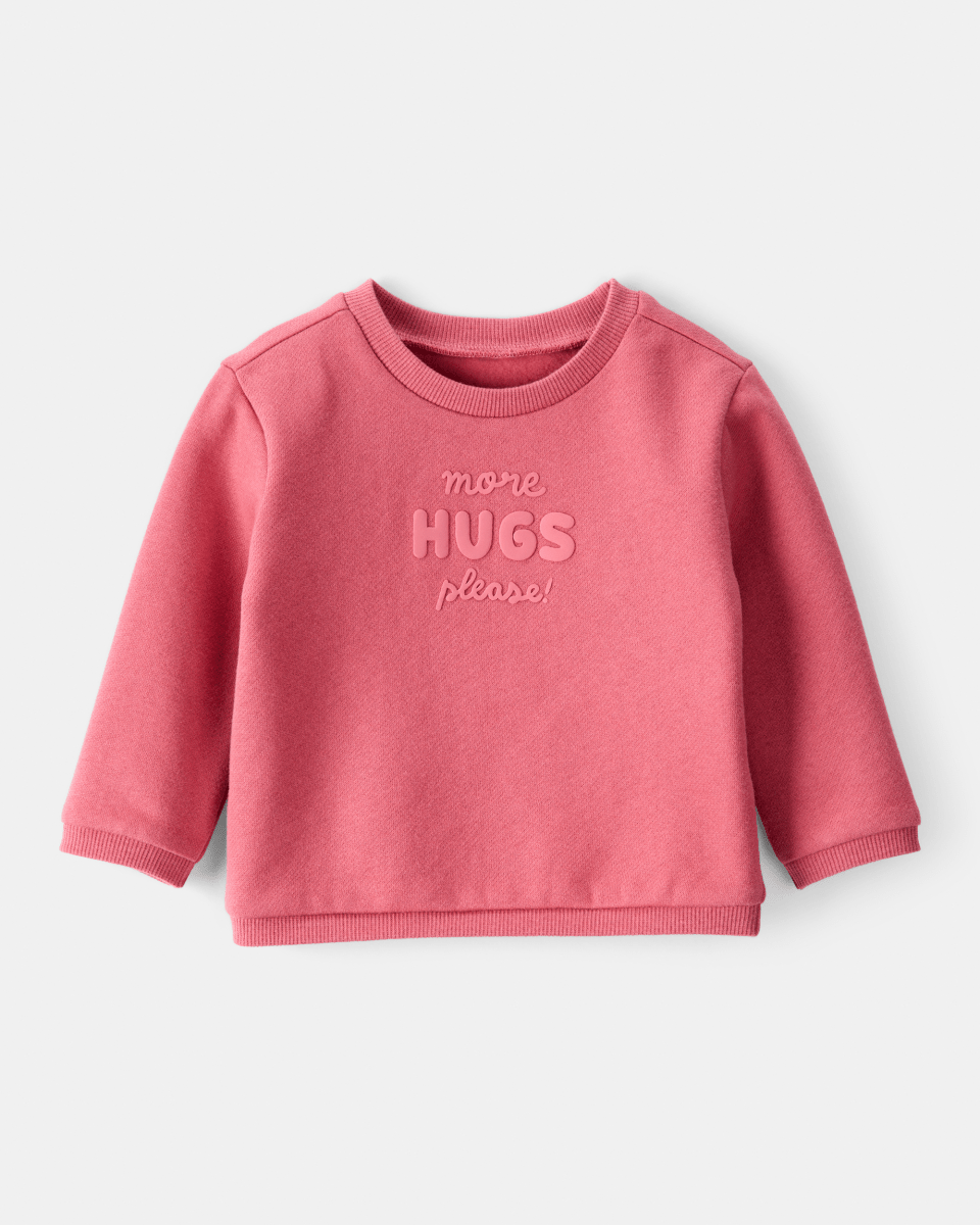 Sudadera rosa con mensaje “More Hugs Please”